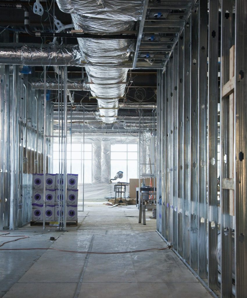 interior of construction site with exposed ducts and metal joists .jpg